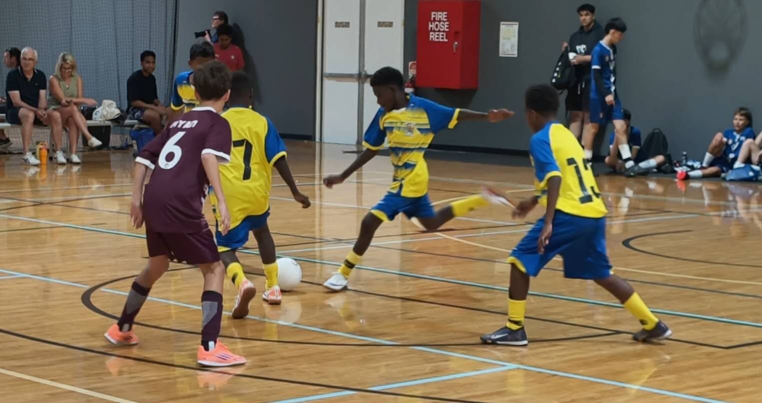 A Chung Wah player on the ball against an Australian team